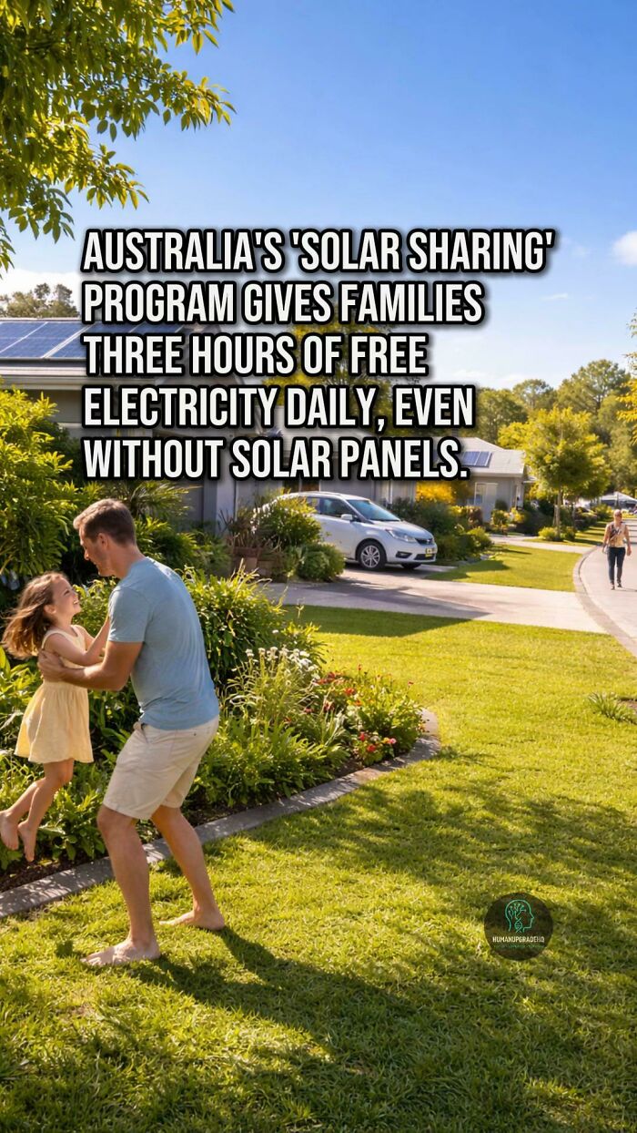 Family enjoys sunny day outside homes with solar panels, highlighting positive news about free electricity from solar sharing programs.