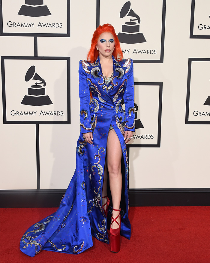 Lady Gaga wearing a detailed blue gown and red platform heels at the 2016 Grammys showcasing fashion evolution in 10 years.