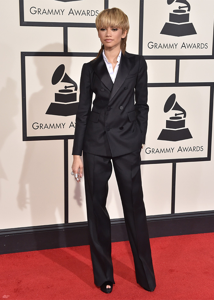 Zendaya wearing a black suit on the red carpet at the 2016 Grammys showing changes in fashion over 10 years.