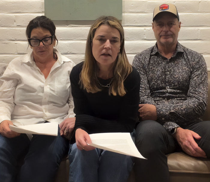 Three people sitting on a couch holding papers, discussing a former CIA member theory on Savannah Guthrie's mom disappearance.