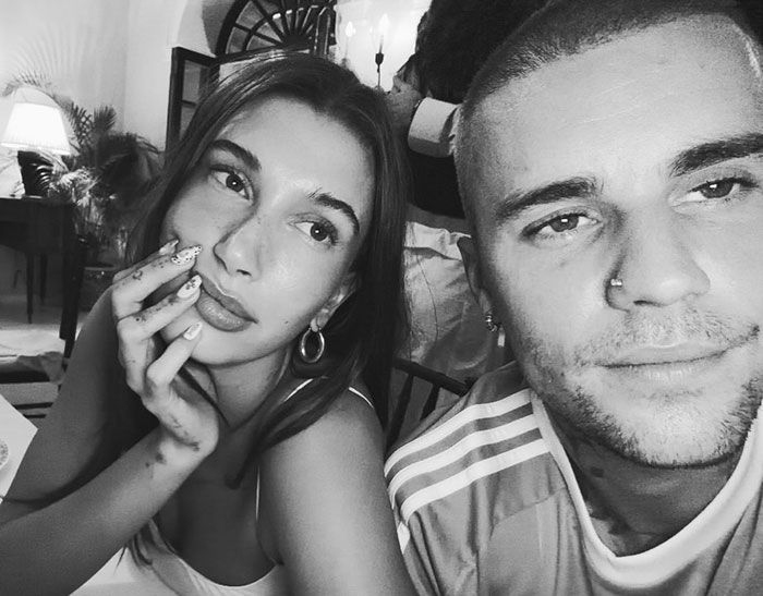 Justin and Hailey Bieber in a candid moment analyzed by lip reader revealing tension during the Super Bowl event.