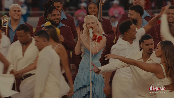 Crowd and performers on stage during Super Bowl halftime show featuring Bad Bunny's wedding-themed performance.