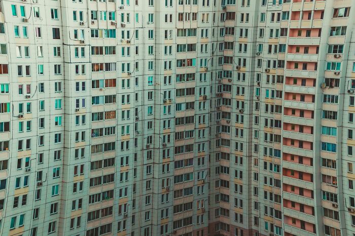 High-rise apartment building with numerous windows, illustrating scenarios of time but no energy or energy but no time.