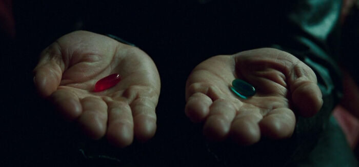 Hands holding a red and a blue pill, symbolizing the choice between time but no energy, or energy but no time.