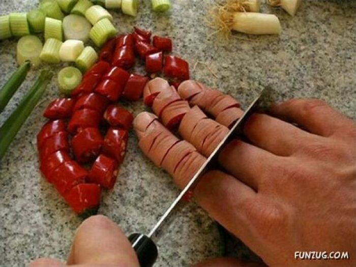 Hand slicing hot dogs that look like fingers next to chopped peppers and green onions in wild Photoshop-like edited image.