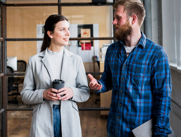 Woman and man having a serious conversation indoors, depicting infertile wife’s reaction to hubby’s baby-making plan question.