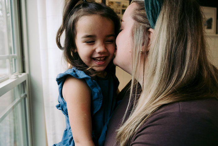 Woman shares her struggles with husband who keeps leaving and coming back while holding her smiling young daughter by the window