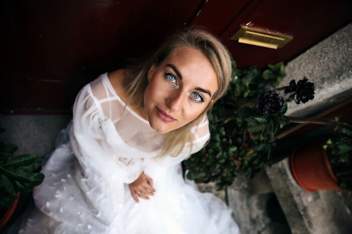 Woman in wedding dress looking up with a hurt expression, highlighting wife hurt about husband&rsquo;s reaction to her wedding look