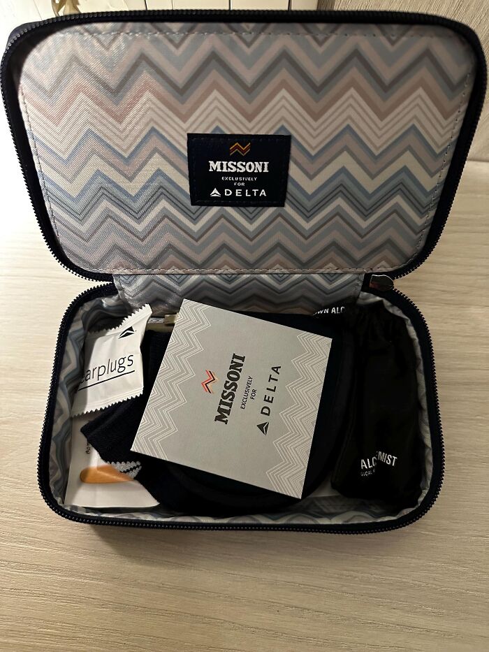 Delta Airlines amenity kit with Missoni design, including earplugs and other travel perks inside a patterned case.