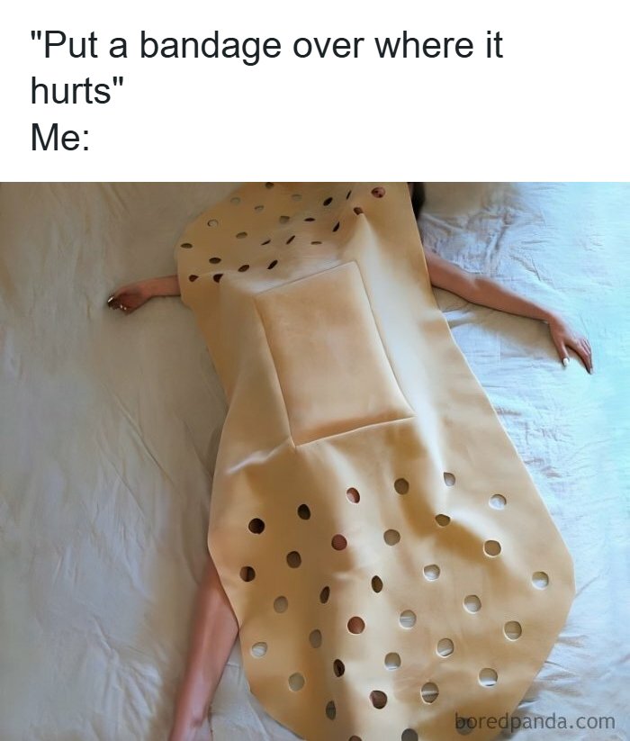 Person lying down covered with an oversized bandage costume, humorous healthcare memes about pain relief.