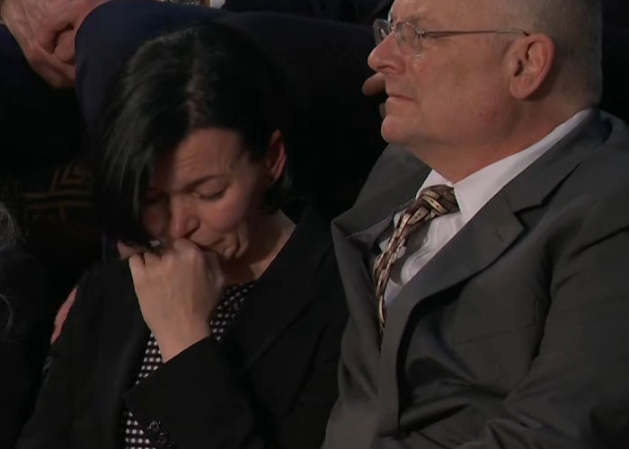 A woman emotional and wiping her face beside a man in glasses during the most viral moments from State of the Union address.