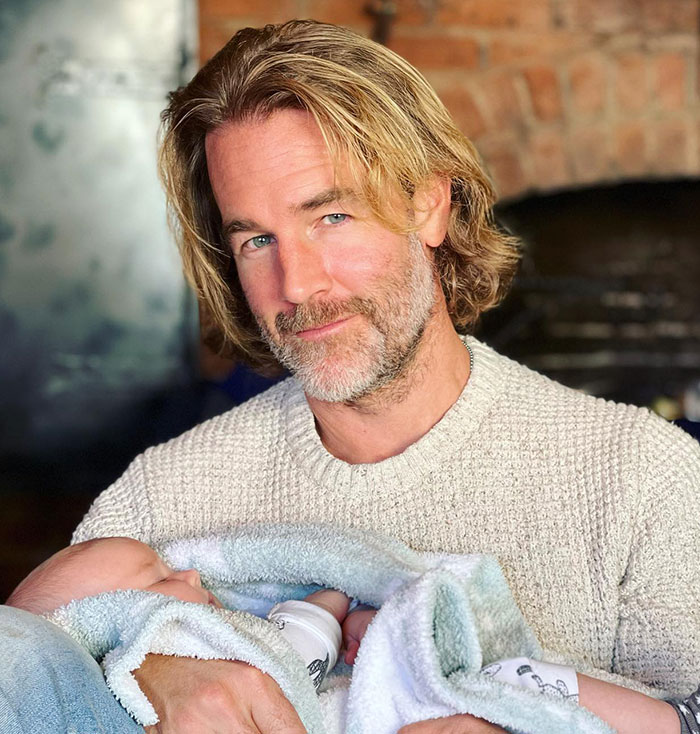 Man with shoulder-length hair and beard holds baby wrapped in blanket, linked to cringy viral Dawson's Creek scene debate.
