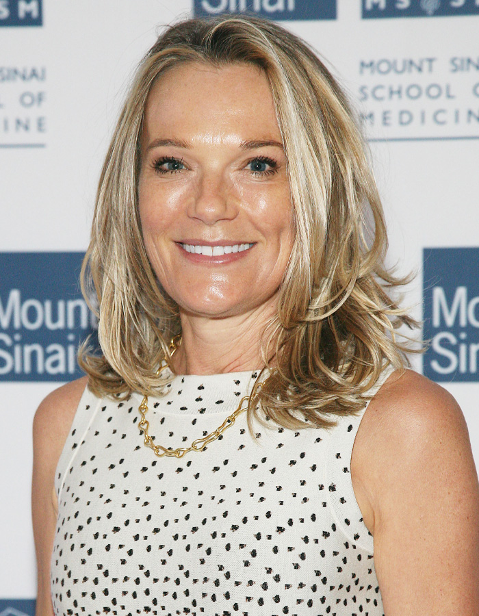 Blonde woman smiling at event with Mount Sinai School of Medicine backdrop, related to Epstein obsession details.