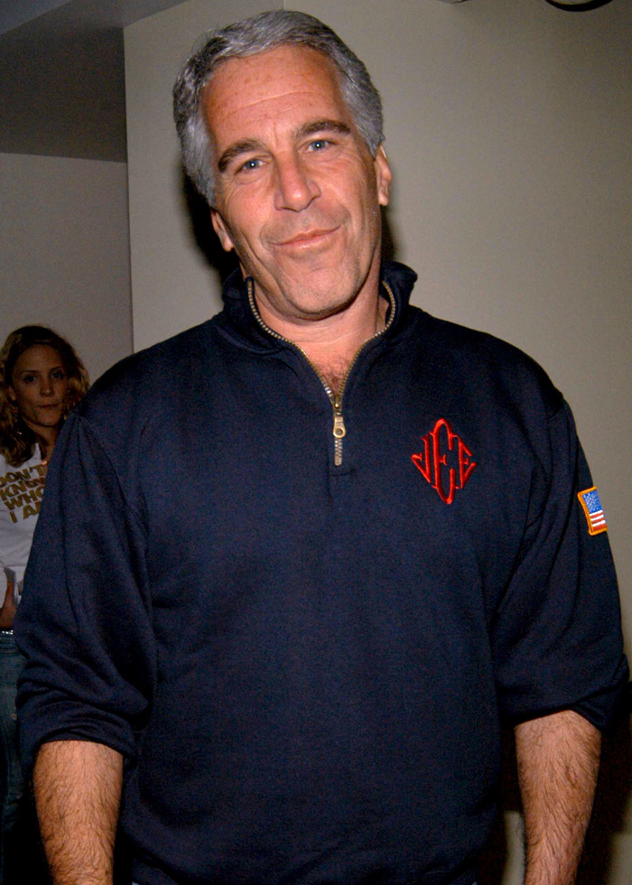 Jeffrey Epstein posing indoors in a navy pullover, linked to bold request about Princess Beatrice and Eugenie in new files