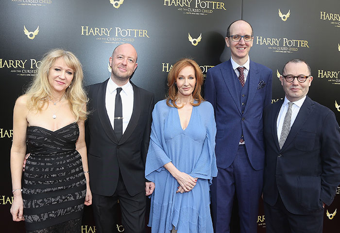 J.K. Rowling posing with colleagues at a Harry Potter event, relating to Jeffrey Epstein accusations discussion.