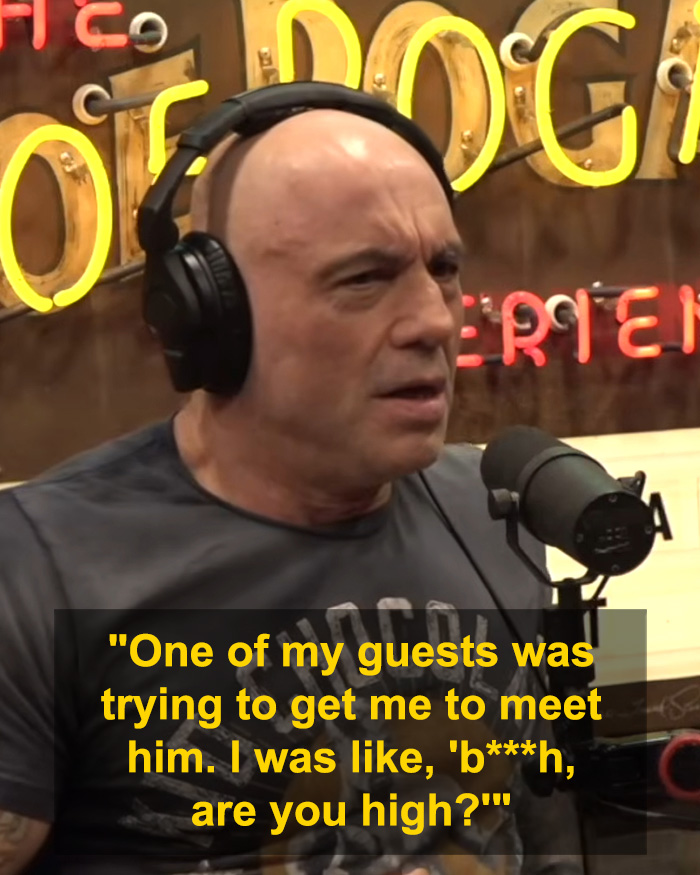 Joe Rogan speaking into a microphone wearing headphones during a podcast recording session.