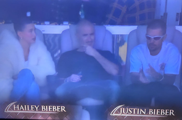 Justin and Hailey Bieber seated at Super Bowl, captured during a tense moment analyzed by a lip reader.