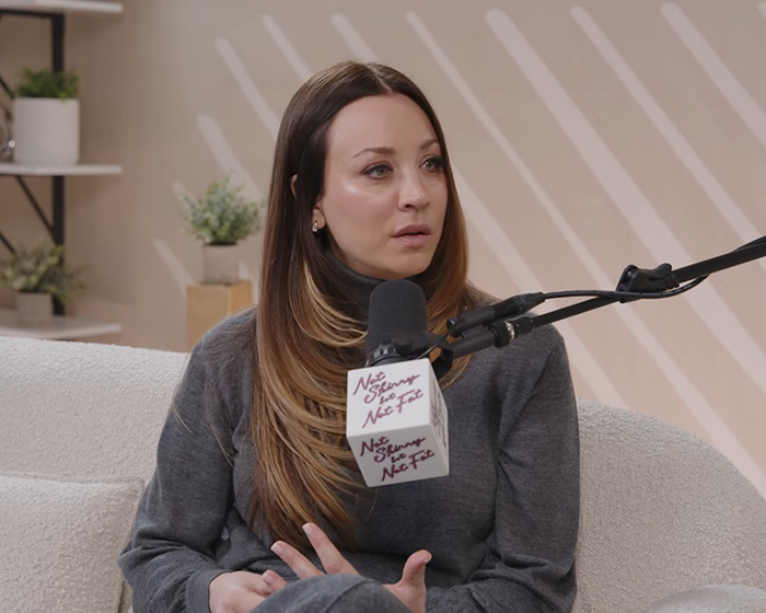 Kaley Cuoco speaking into a microphone during a podcast, discussing her experience with Botox on Big Bang Theory.