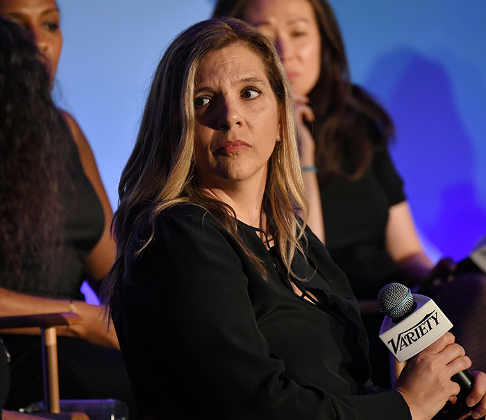 Woman holding a Variety microphone at a panel discussion, focused on Eric Dane’s ALS diagnosis symptom in 2025.