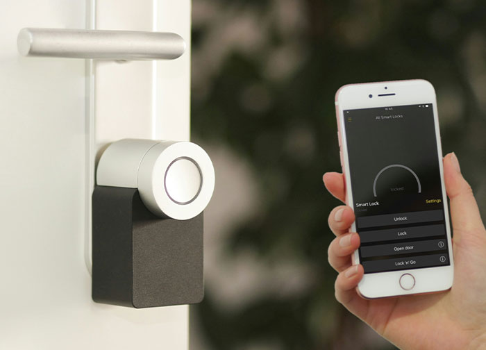 Smart lock on a door controlled by a smartphone app, illustrating security and control concepts related to divorce lawyers cases.