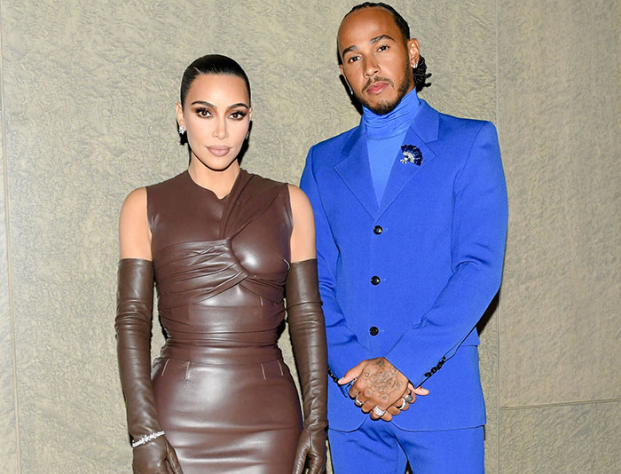 Kim Kardashian and Lewis Hamilton posing together, showing tightly controlled body language expert analysis.
