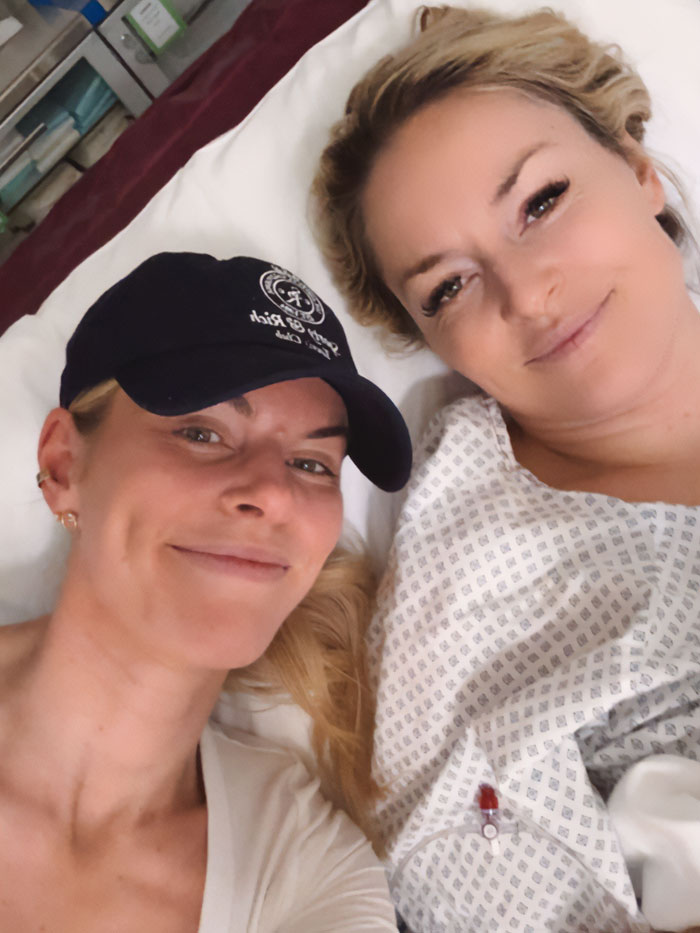 Lindsey Vonn lying in hospital bed with friend, showing update after horrific Olympics accident and growing backlash.
