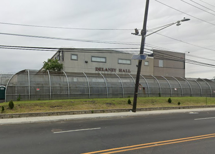 Delaney Hall detention center exterior with fenced perimeter and street view, related to MAGA influencer detained by ICE.