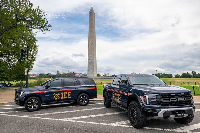 Two ICE vehicles parked near the Washington Monument, representing immigration enforcement and MAGA influencer detention.