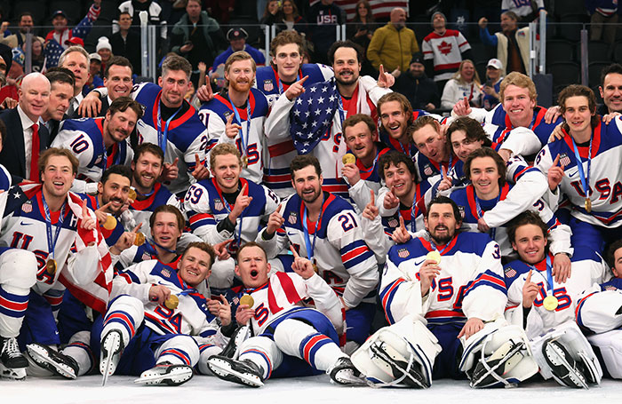 US women's hockey players in team uniforms celebrating on ice, breaking silence on distasteful joke and Trump's remark.