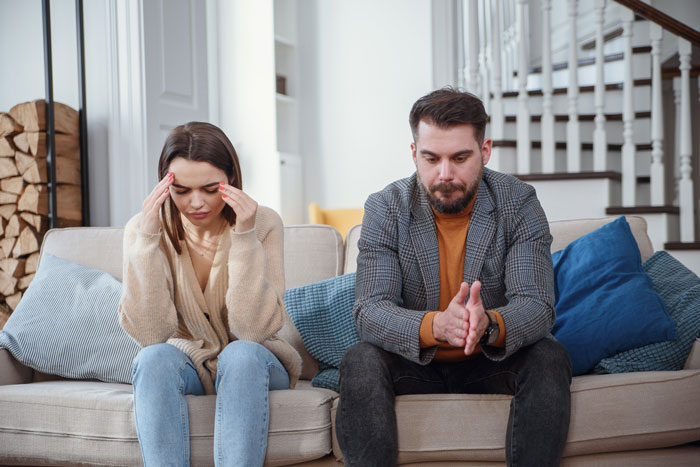Couple in shock sitting on couch, distressed after religious MIL kidnaps their son in revenge, facing emotional turmoil at home. Couple in shock sitting on couch, distressed after religious MIL kidnaps their son in revenge, facing emotional turmoil at home.