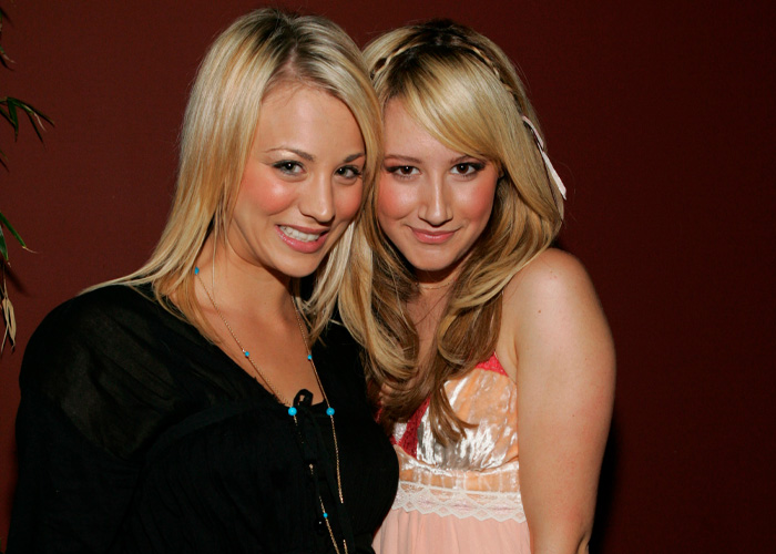 Two smiling women posing together indoors, highlighting the toxic mom drama and Kaley Cuoco&rsquo;s confrontation with Ashley Tisdale.