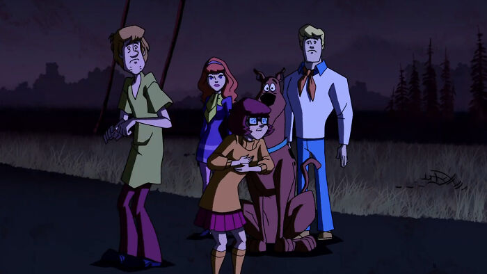 Scooby Doo fans react to controversial pick for Velma with mystery-solving gang standing in dark, wooded area.