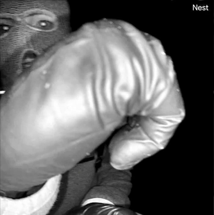 Masked person wearing boxing gloves captured on security camera, related to Nancy Guthrie kidnapping video clue decoded by police experts