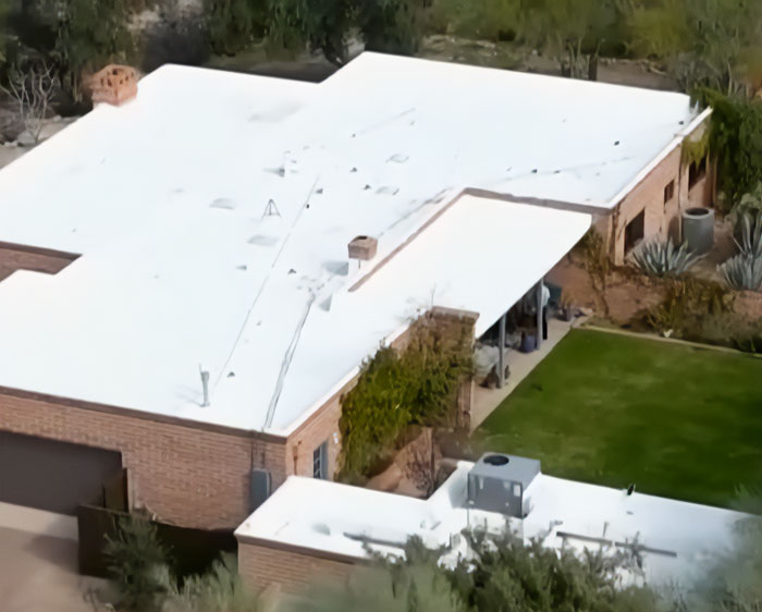 Aerial view of a house with a white roof involved in a police roof search after neighbor's crucial information.