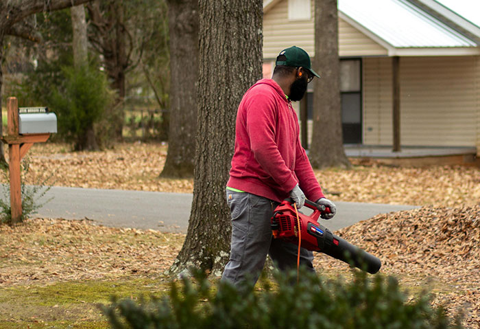 Man using snowblower outside, ensuring neighbor&rsquo;s driveway is the only one snowed in during winter.