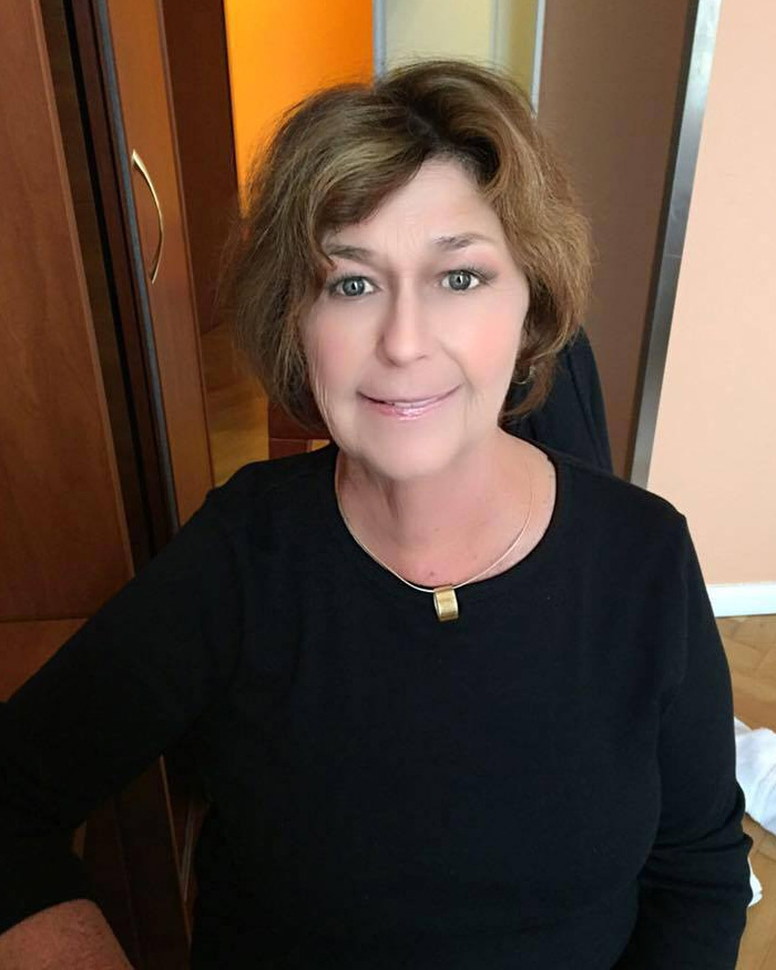 Woman with short brown hair wearing a black top, related to terrifying images of Nancy Guthrie suspect released by FBI.