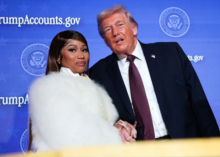 Nicki Minaj with a dramatic new look posing alongside a man in a suit during a public event.