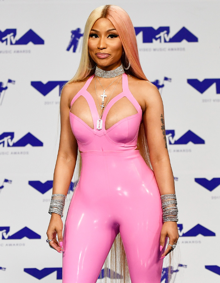 Nicki Minaj in a striking pink outfit with two-tone hair at the MTV Video Music Awards, showcasing her dramatic new look.