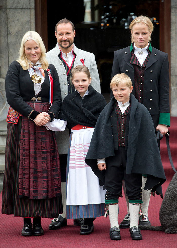 Norway's Crown Princess family in traditional attire, with son heading to court on charges in a high-profile case.