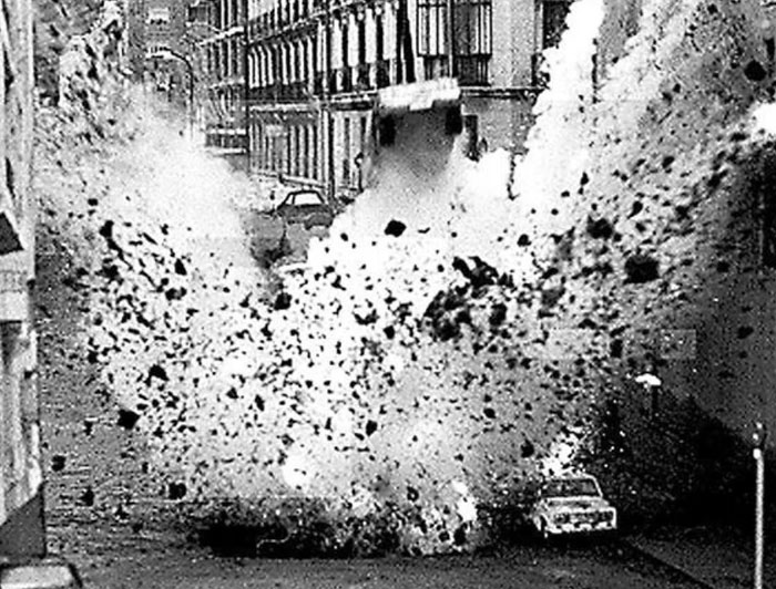 Black and white photo capturing a powerful explosion on an urban street in one of the powerful photos from all over the world