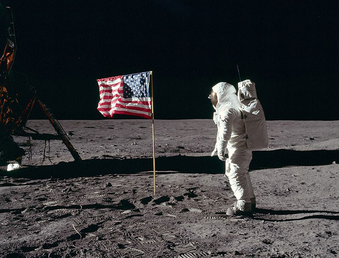 Astronaut standing on the moon next to an American flag, one of the powerful photos from all over the world.
