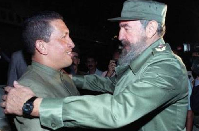 Two men in military-style clothing warmly embracing in a powerful photo from all over the world.