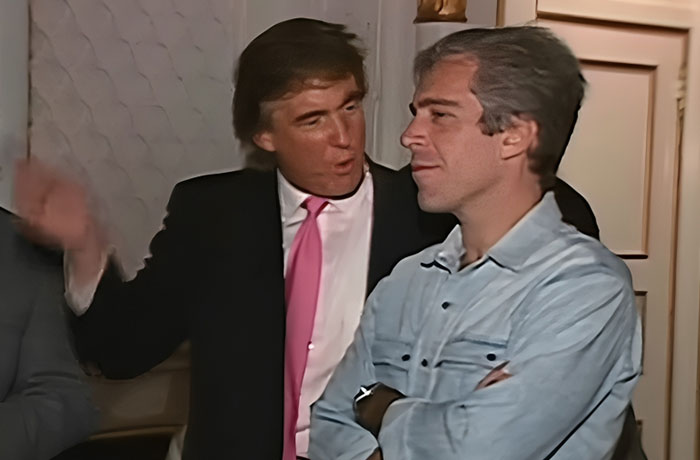Two men engaged in conversation indoors, one wearing a black suit with a pink tie, captured in powerful photos.