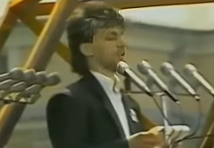 Man speaking passionately into multiple microphones at an outdoor event, one of 29 powerful photos from all over the world