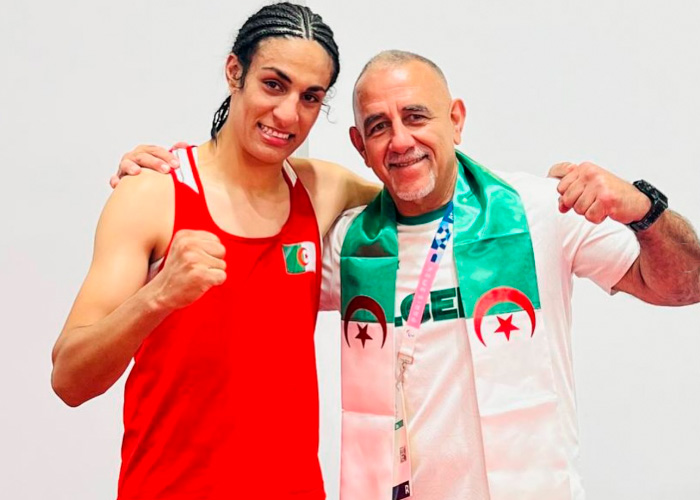 Imane Khelif posing with a coach, both showing strength, highlighting the controversy over Y chromosome gene admission.