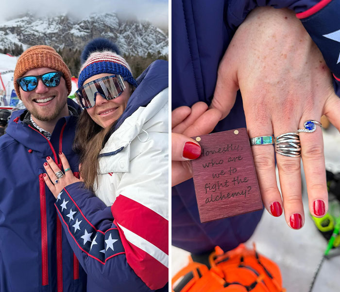 Couple smiling in winter gear at the 2026 Winter Olympics showing unique rings and a wooden tag with writing.