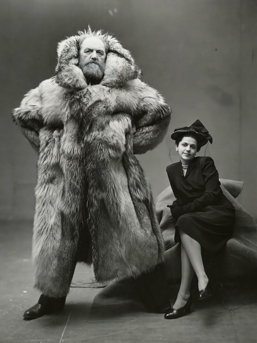 Man wearing a large fur coat and a woman in vintage attire posing, representing iconic gigachads admired worldwide.