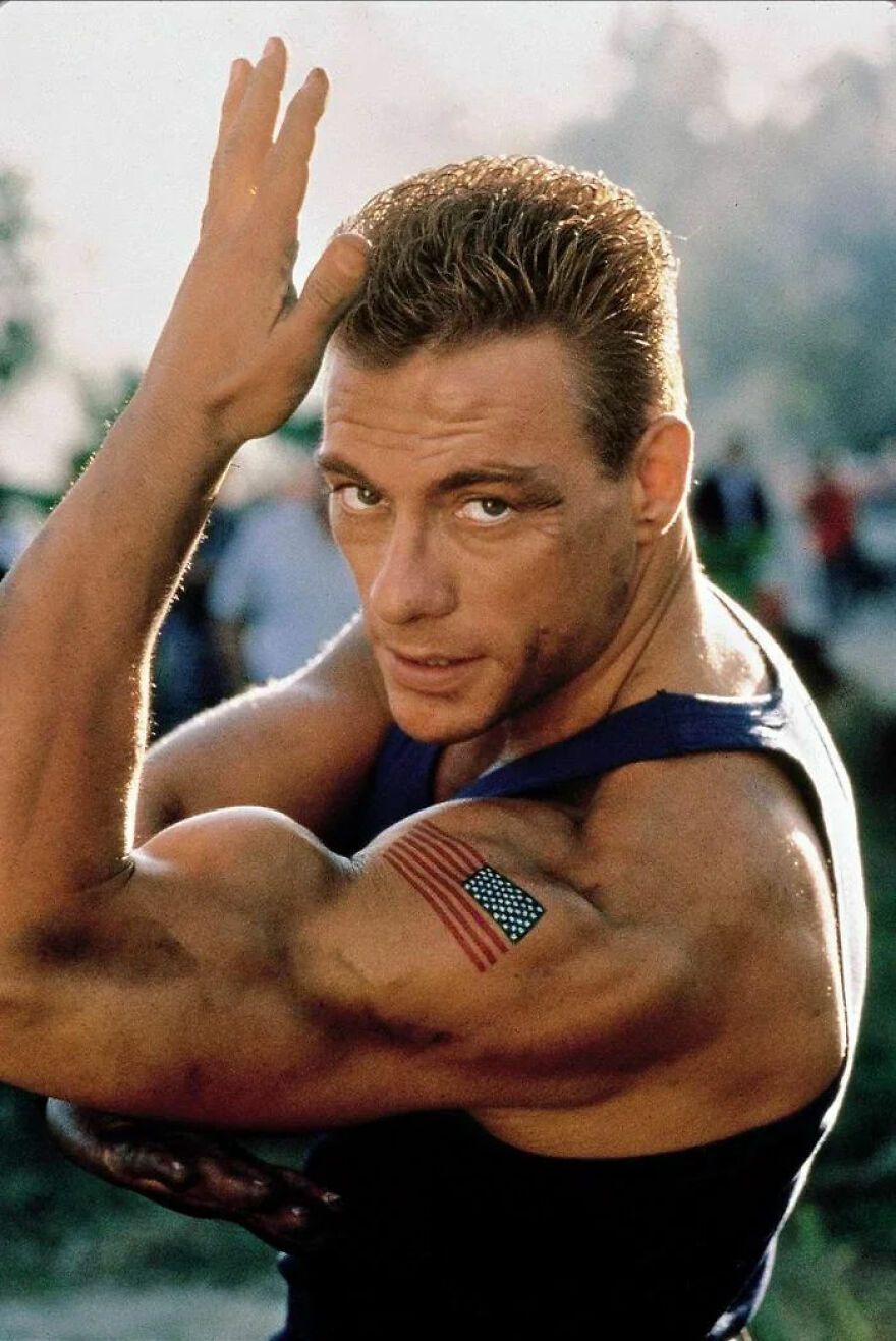 Muscular man with American flag tattoo flexing bicep, embodying strength and confidence like a famous Gigachad figure.