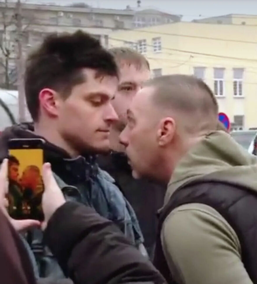 Two men confronting each other closely in a crowded outdoor setting, highlighted in a photo capturing Gigachads tension.