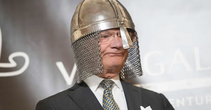 Man wearing medieval helmet and chainmail with suit and tie, representing a gigachad admired in his country.